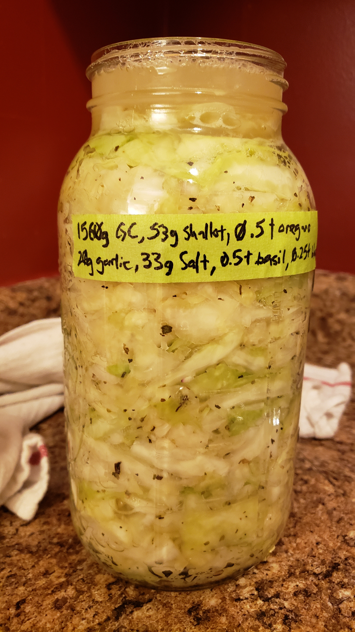 The ferment from the last post. It is dulling in color, 
      the herbs have swollen with liquid a bit, and the cabbage is becoming a bit more translucent.
